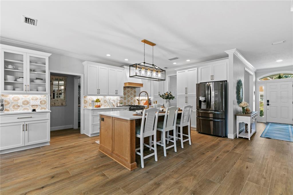 11981 Southwest 1st Road Gainesville, FL 32607 - Photo 10 of 49 a kitchen with kitchen island wooden floors appliances and cabinets