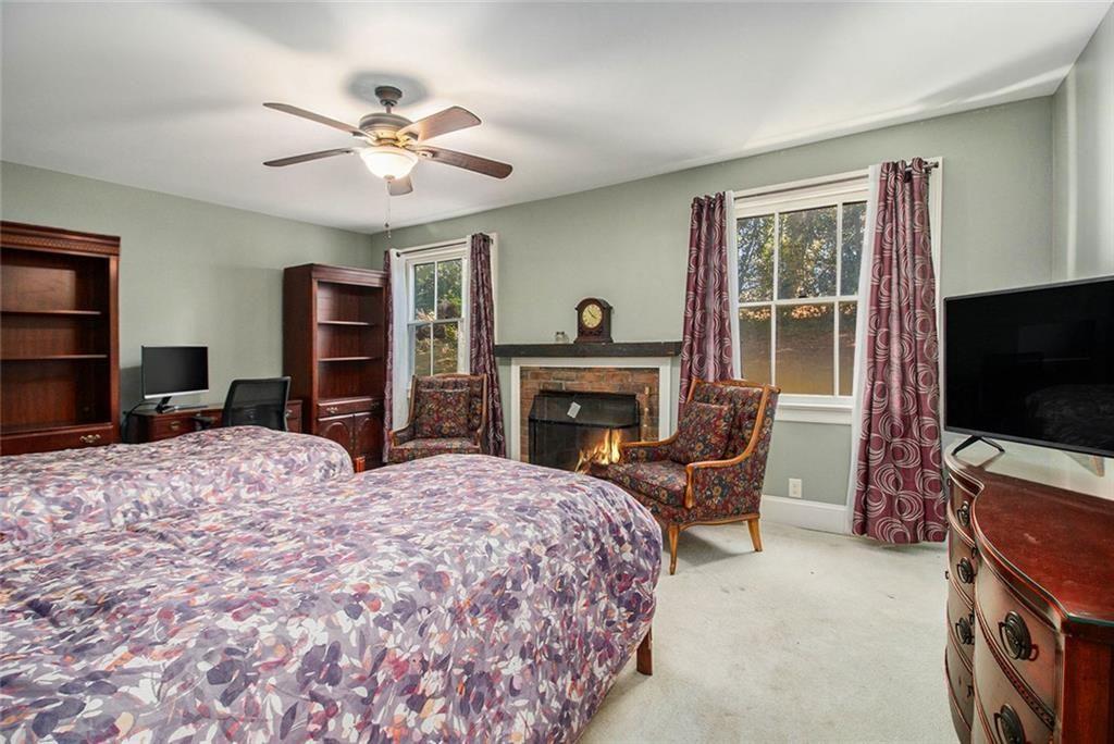 112 Hillcrest Road West Point, GA 31833 - Photo 26 of 34 a bedroom with a bed and a flat screen tv with dresser