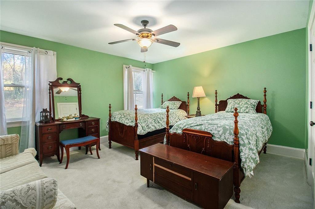 112 Hillcrest Road West Point, GA 31833 - Photo 27 of 34 a bedroom with a bed and a chandelier