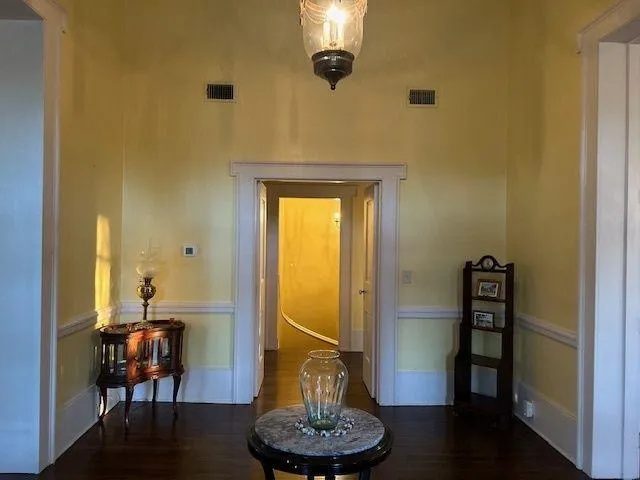 a view of a livingroom with a table and a chair