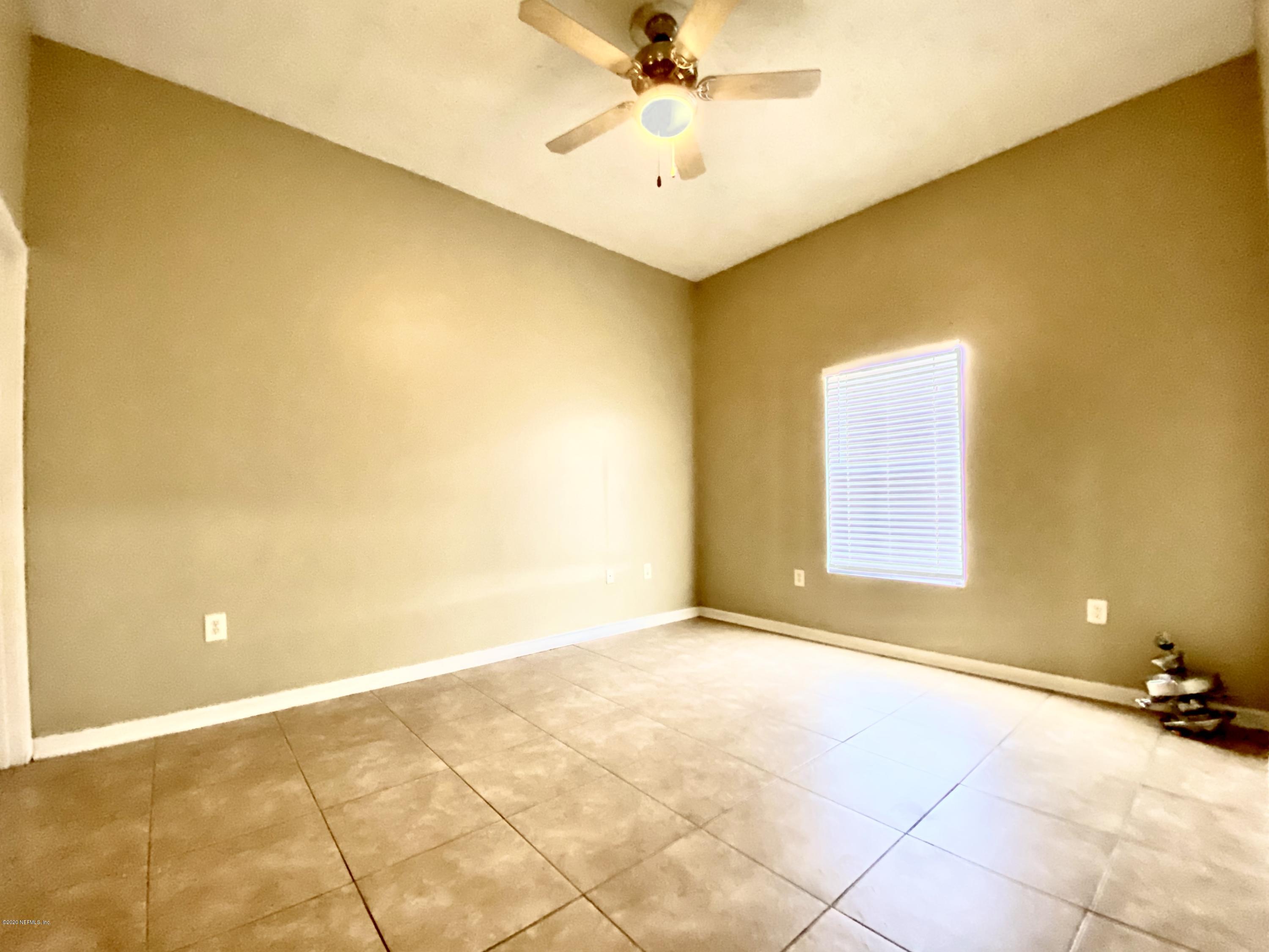 7920 Merrill Road, Unit 707 Jacksonville, FL 32277 - Photo 11 of 13 a view of an empty room with a window