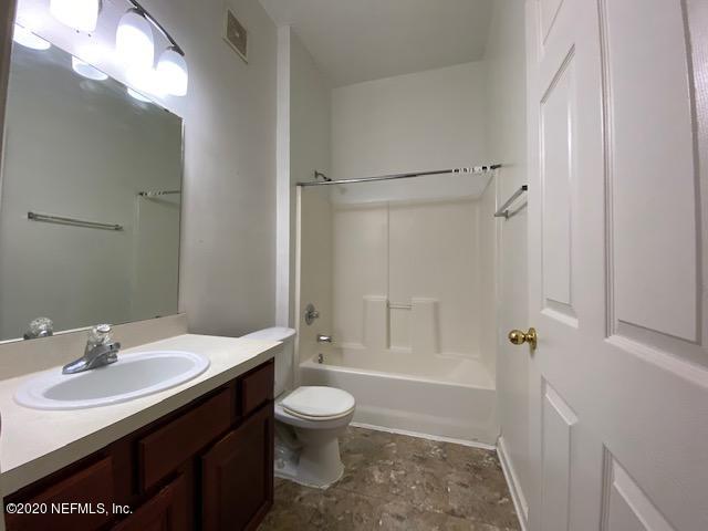 7920 Merrill Road, Unit 707 Jacksonville, FL 32277 - Photo 13 of 13 a bathroom with a sink a toilet and shower