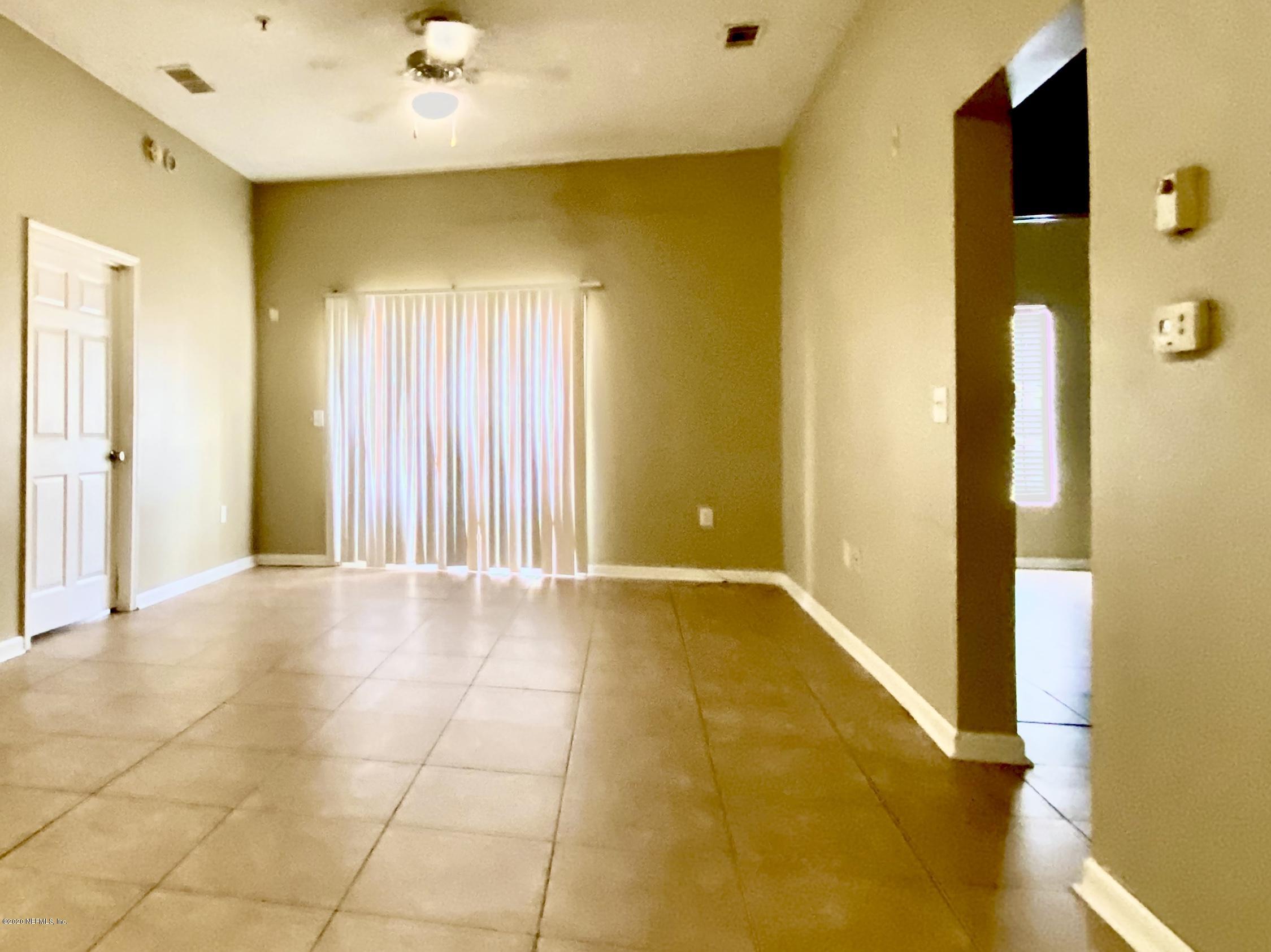 7920 Merrill Road, Unit 707 Jacksonville, FL 32277 - Photo 5 of 13 a view of an empty room with a door