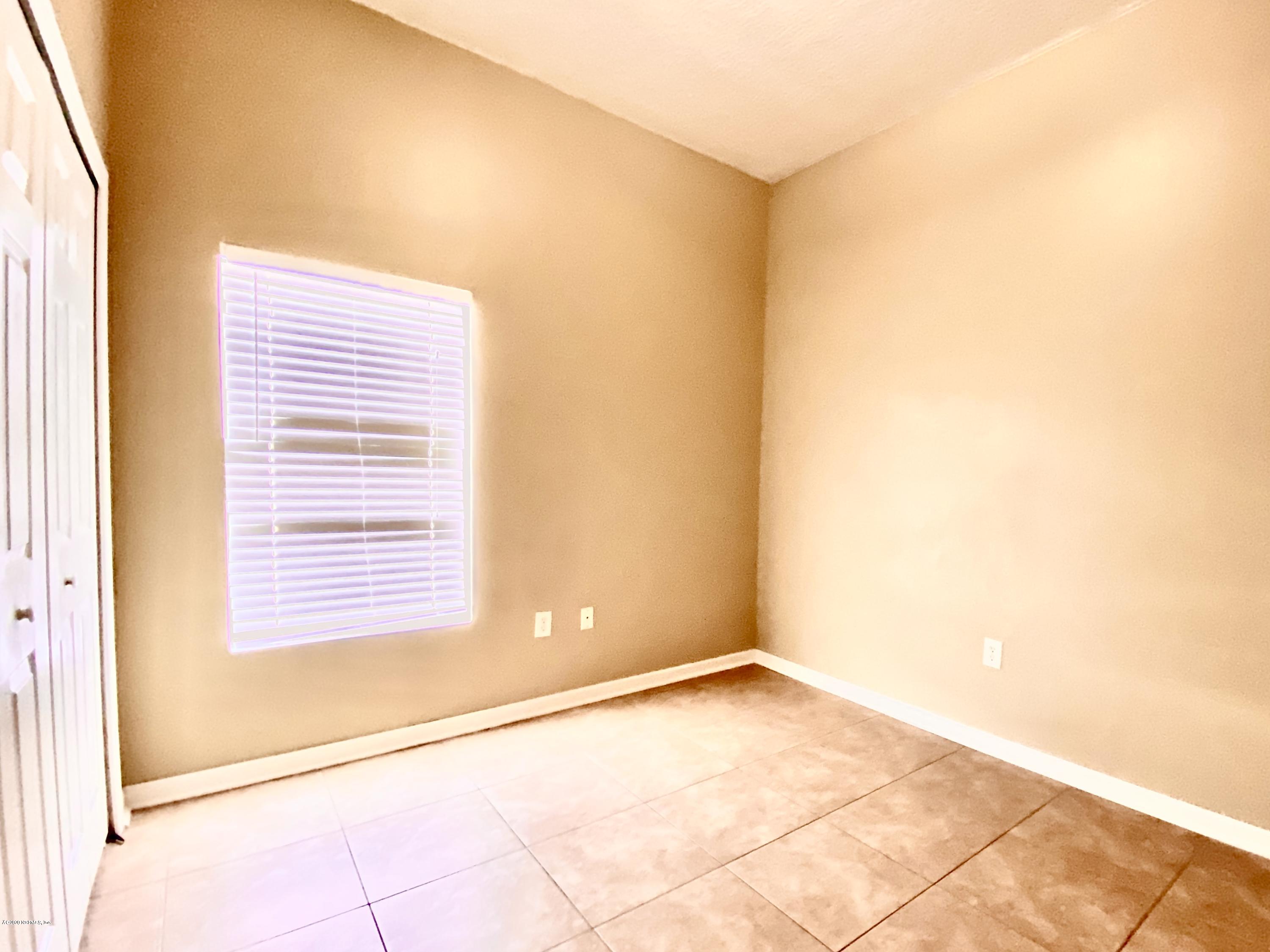7920 Merrill Road, Unit 707 Jacksonville, FL 32277 - Photo 8 of 13 a view of a room with a air conditioner and a window