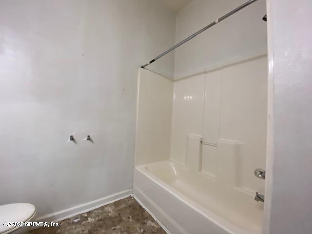 7920 Merrill Road, Unit 707 Jacksonville, FL 32277 - Photo 9 of 13 a bathroom with a bathtub and a toilet