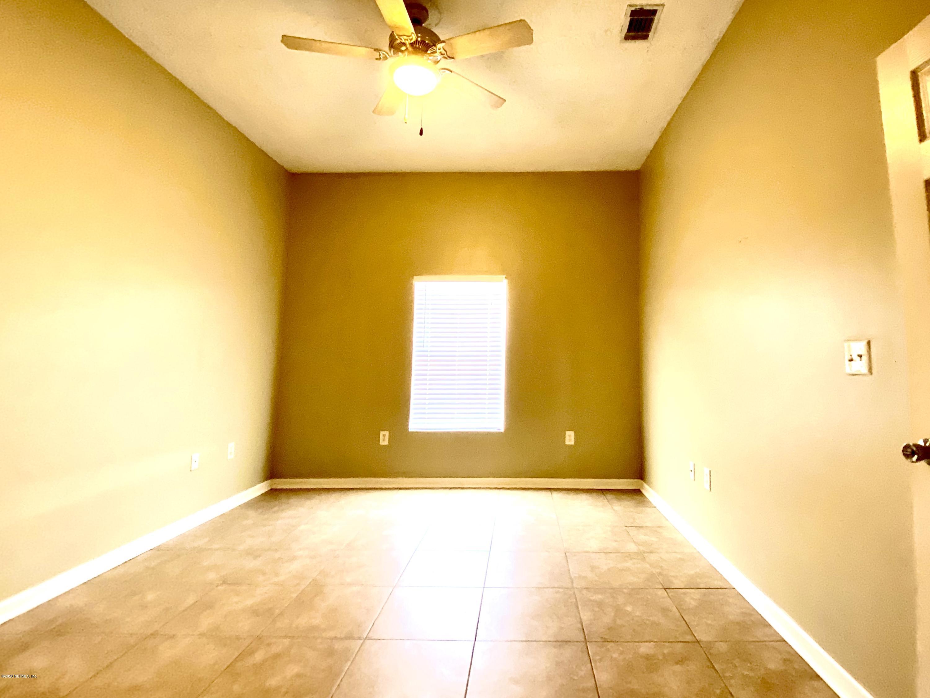7920 Merrill Road, Unit 707 Jacksonville, FL 32277 - Photo 10 of 13 a view of a big room with a window