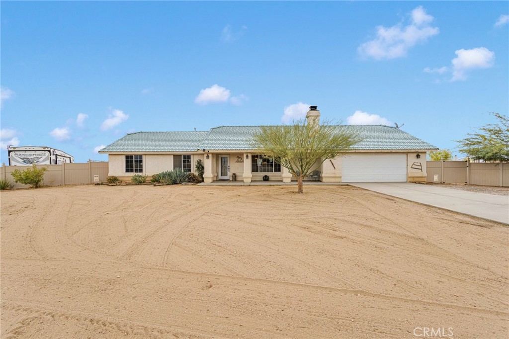 a front view of house with a garden