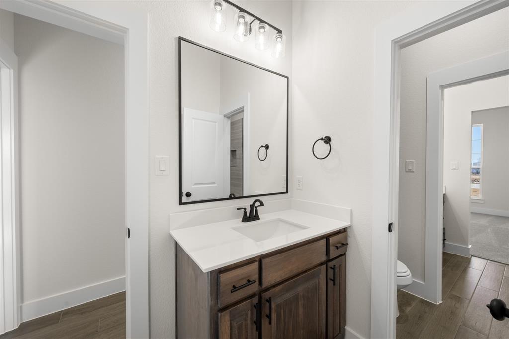 4867 Prairie Sky Lane DISH, TX 76247 - Photo 16 of 27 a bathroom with a sink and a mirror