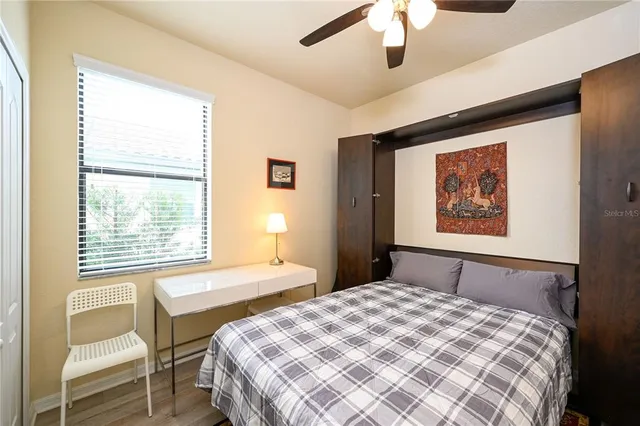 a bedroom with a bed and a painting on the wall