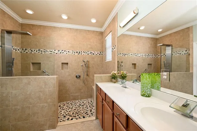 a bathroom with a double vanity sink mirror and shower