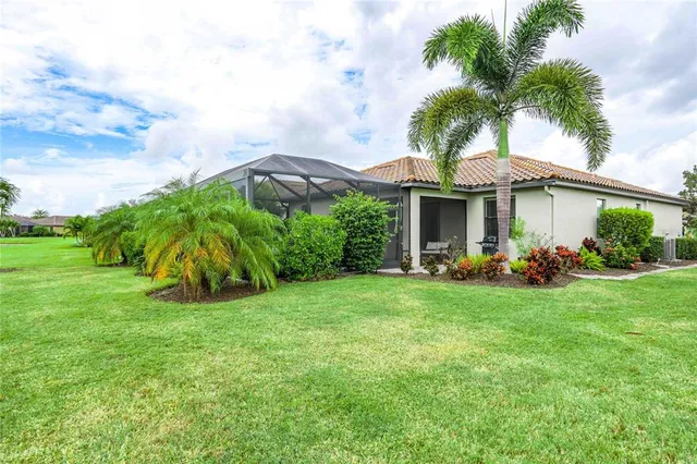 a view of a house with a yard and potted plants