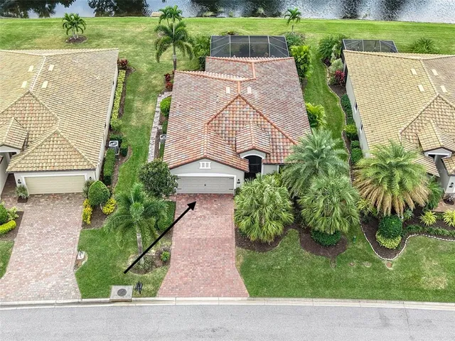 an aerial view of a house with a yard