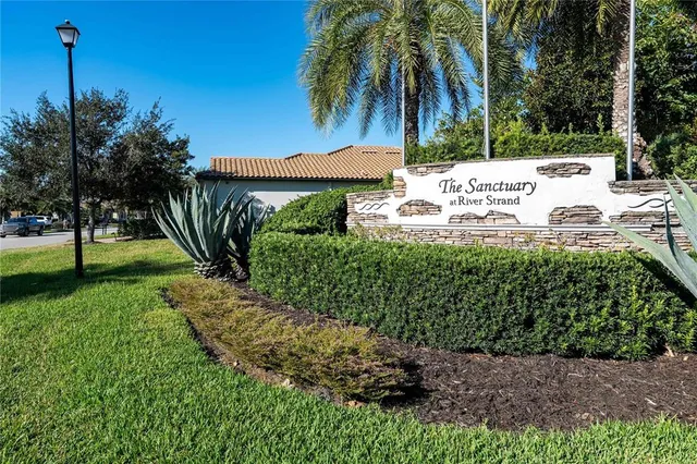 a view of a house with a yard and potted plants