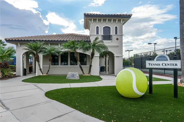 a view of a house with a backyard and a patio