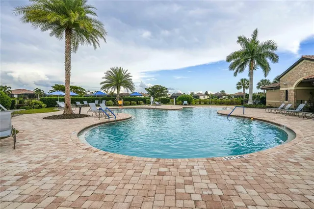 a view of a swimming pool with a table and chairs