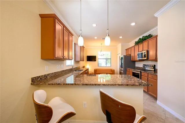 a kitchen with stainless steel appliances granite countertop a sink a stove top oven a counter space and cabinets