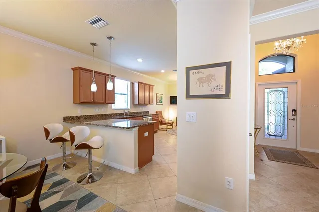 a kitchen with stainless steel appliances kitchen island granite countertop a refrigerator and a stove top oven