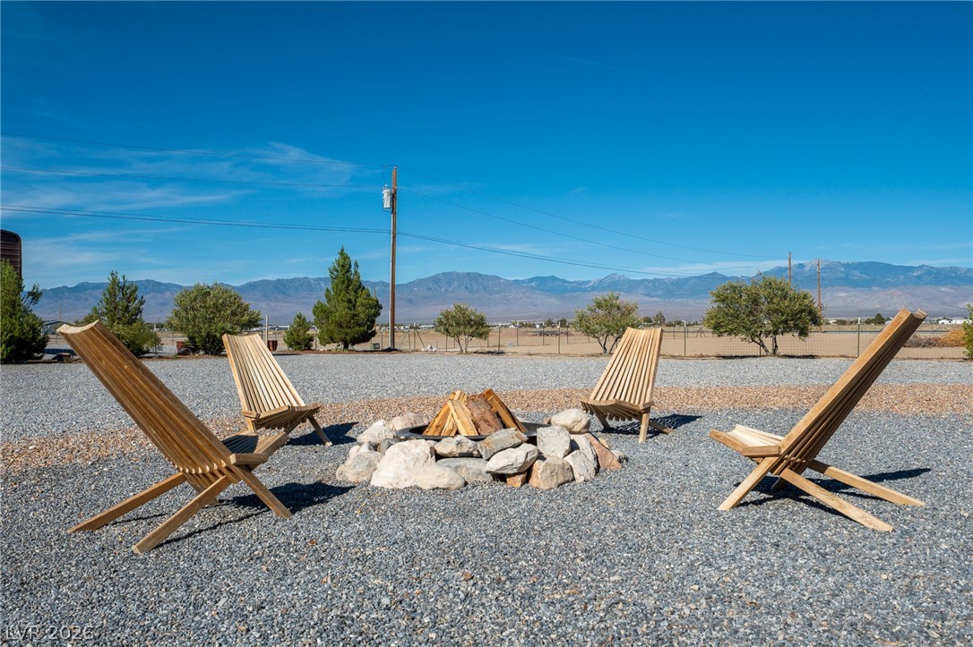 4080 Magnet Road Pahrump, NV 89048 - Photo 20 of 28 An outdoor gathering area looks out over panoramic mountain views under clear blue skies.
