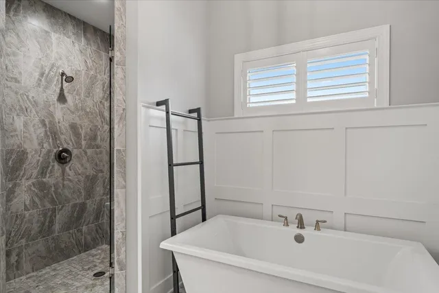 a bathroom with a bathtub and shower