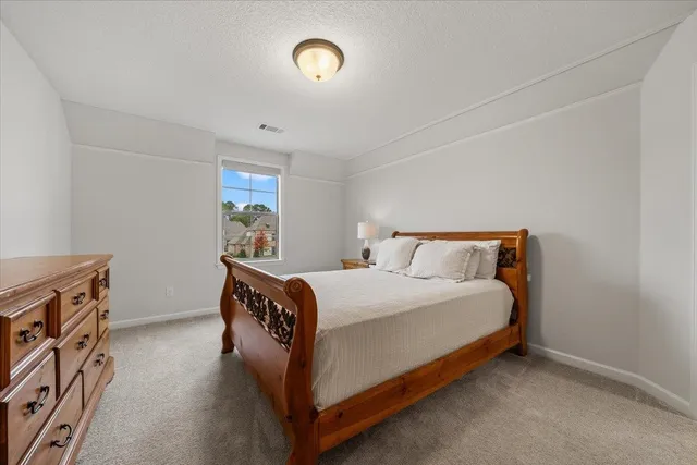 a bathroom with a granite countertop sink a toilet and a mirror
