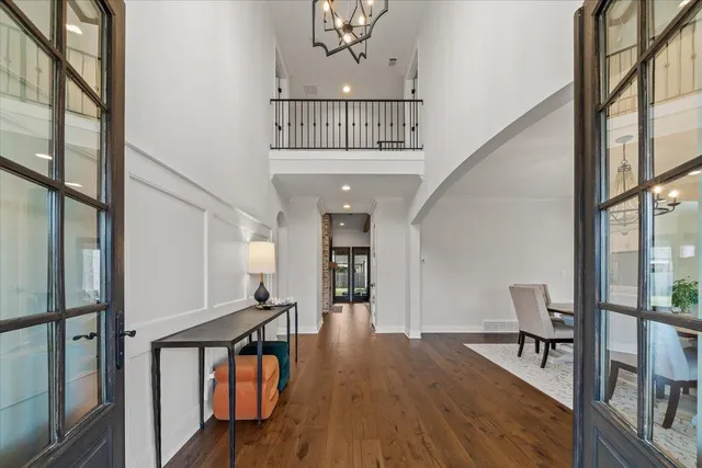 a view of a hallway with wooden floor and staircase