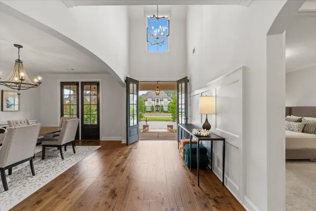 a view of a livingroom with furniture hardwood floor and a large window