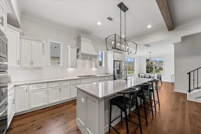 a kitchen with center island table and chairs in it