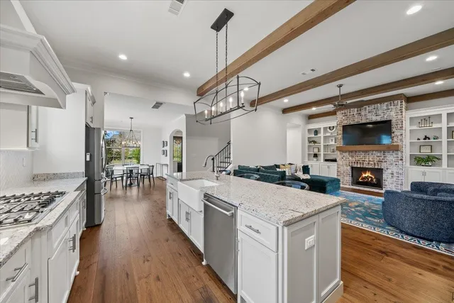 a open kitchen with sink stove and cabinets