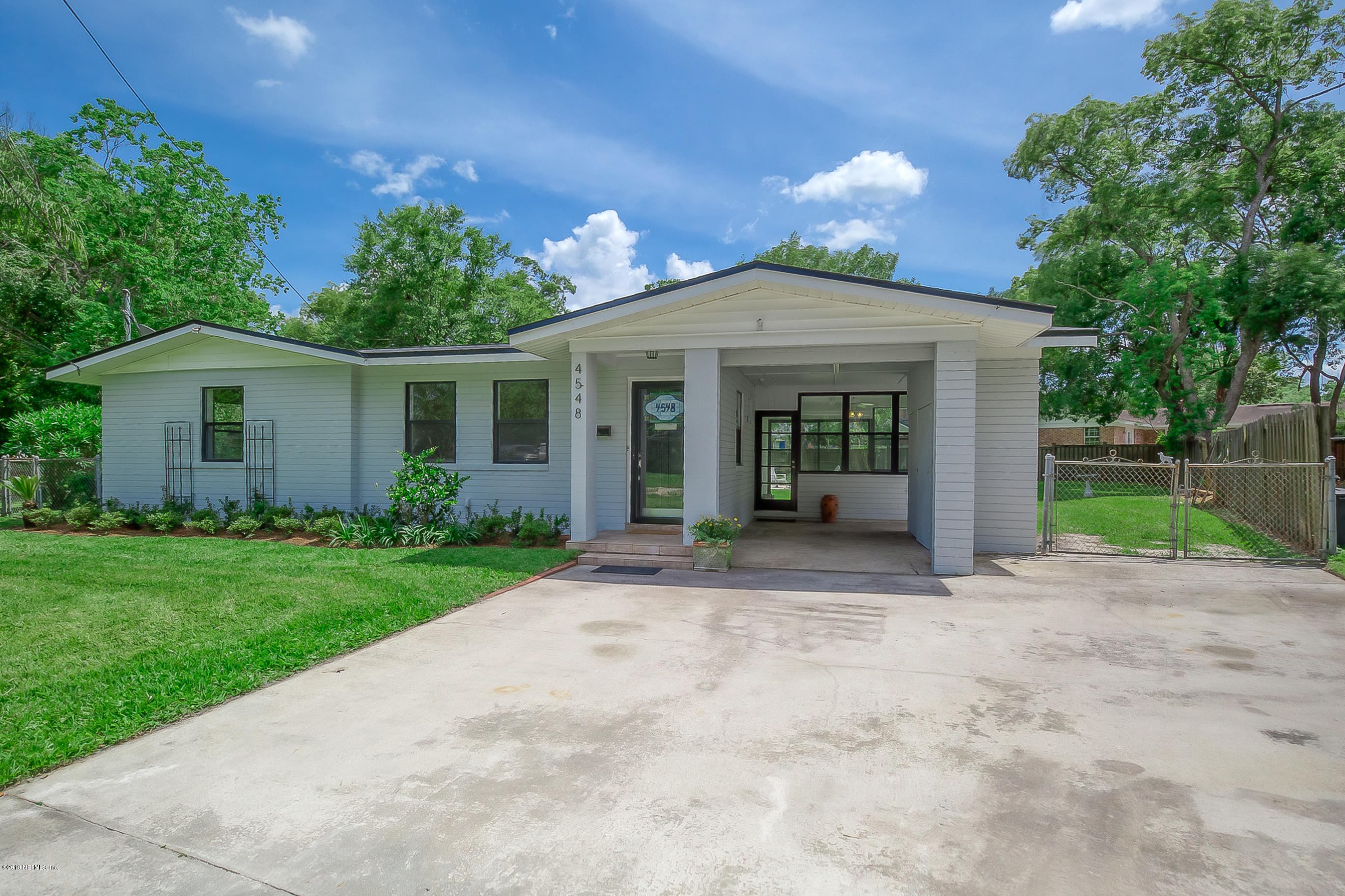 4548 Milstead Road Jacksonville, FL 32210 - Photo 1 of 37 a front view of a house with a garden