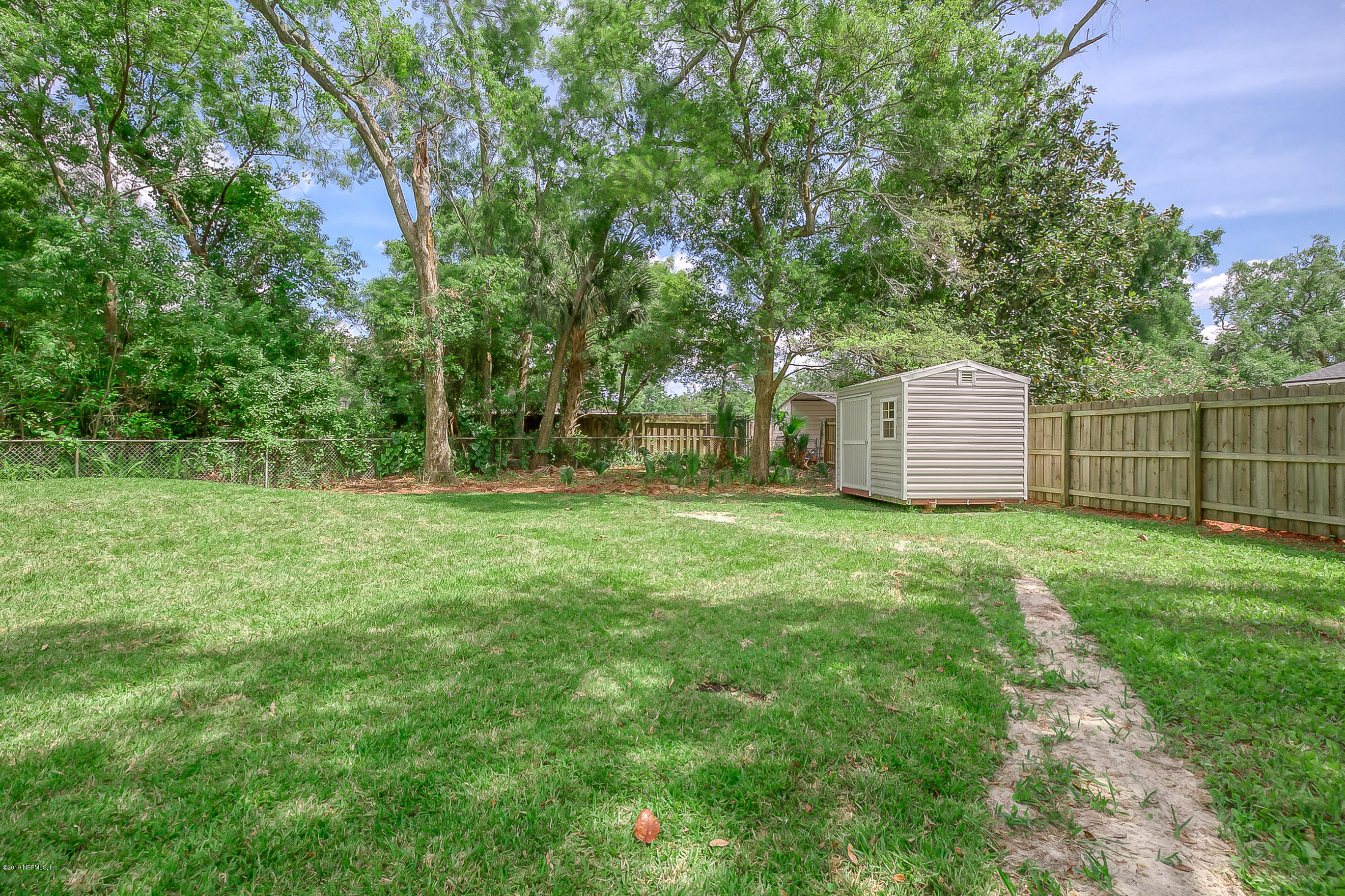 4548 Milstead Road Jacksonville, FL 32210 - Photo 12 of 37 a view of a backyard with large trees