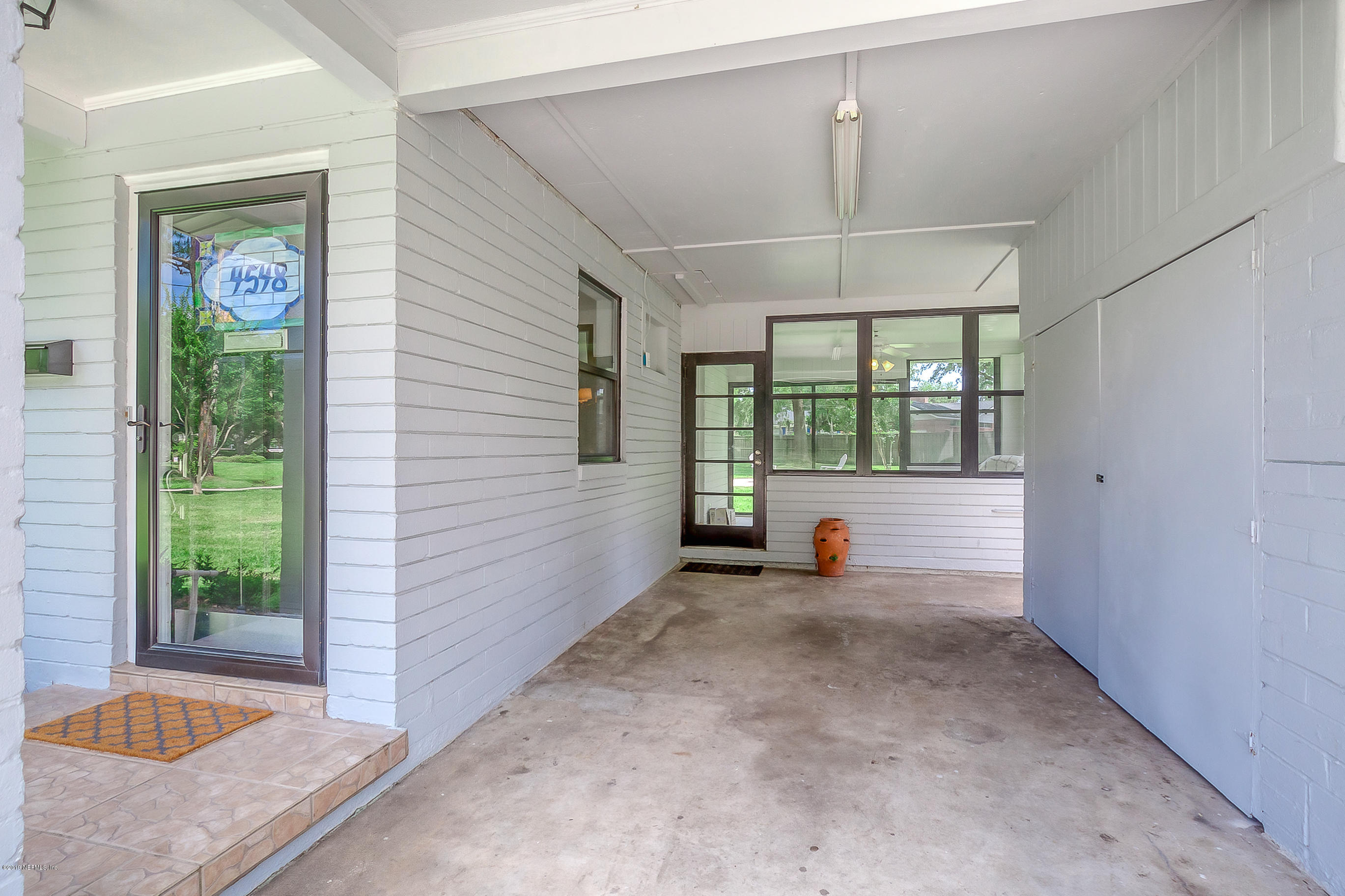 4548 Milstead Road Jacksonville, FL 32210 - Photo 15 of 37 an empty room with windows and outdoor view