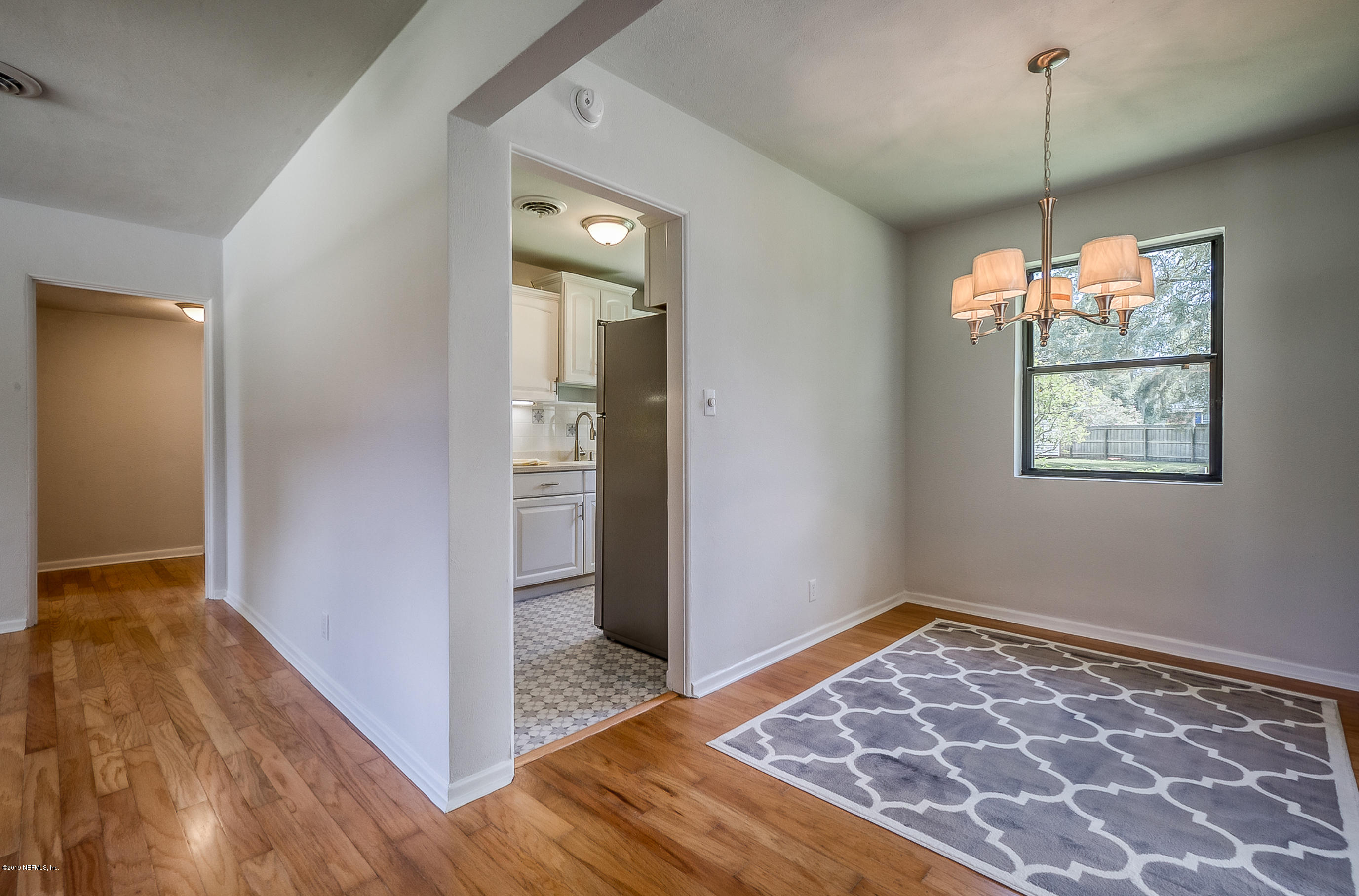 4548 Milstead Road Jacksonville, FL 32210 - Photo 21 of 37 a view of a room with wooden floor and a window