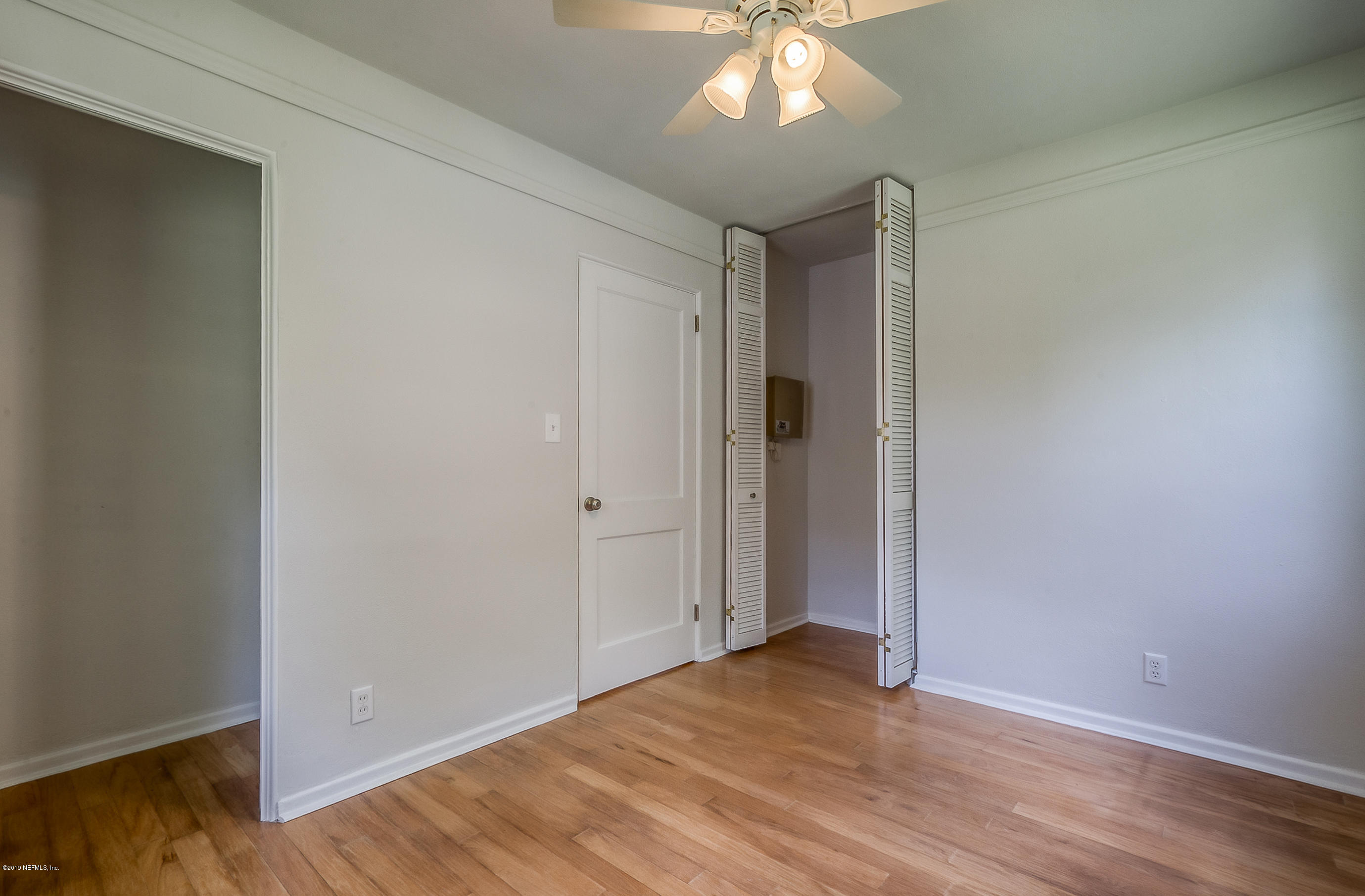 4548 Milstead Road Jacksonville, FL 32210 - Photo 24 of 37 a view of an empty room with wooden floor
