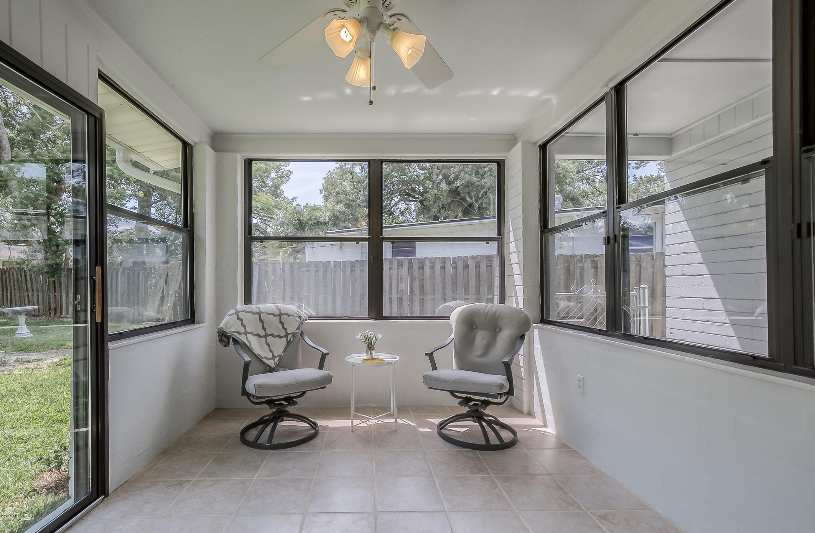 4548 Milstead Road Jacksonville, FL 32210 - Photo 27 of 37 a living room with furniture and floor to ceiling window