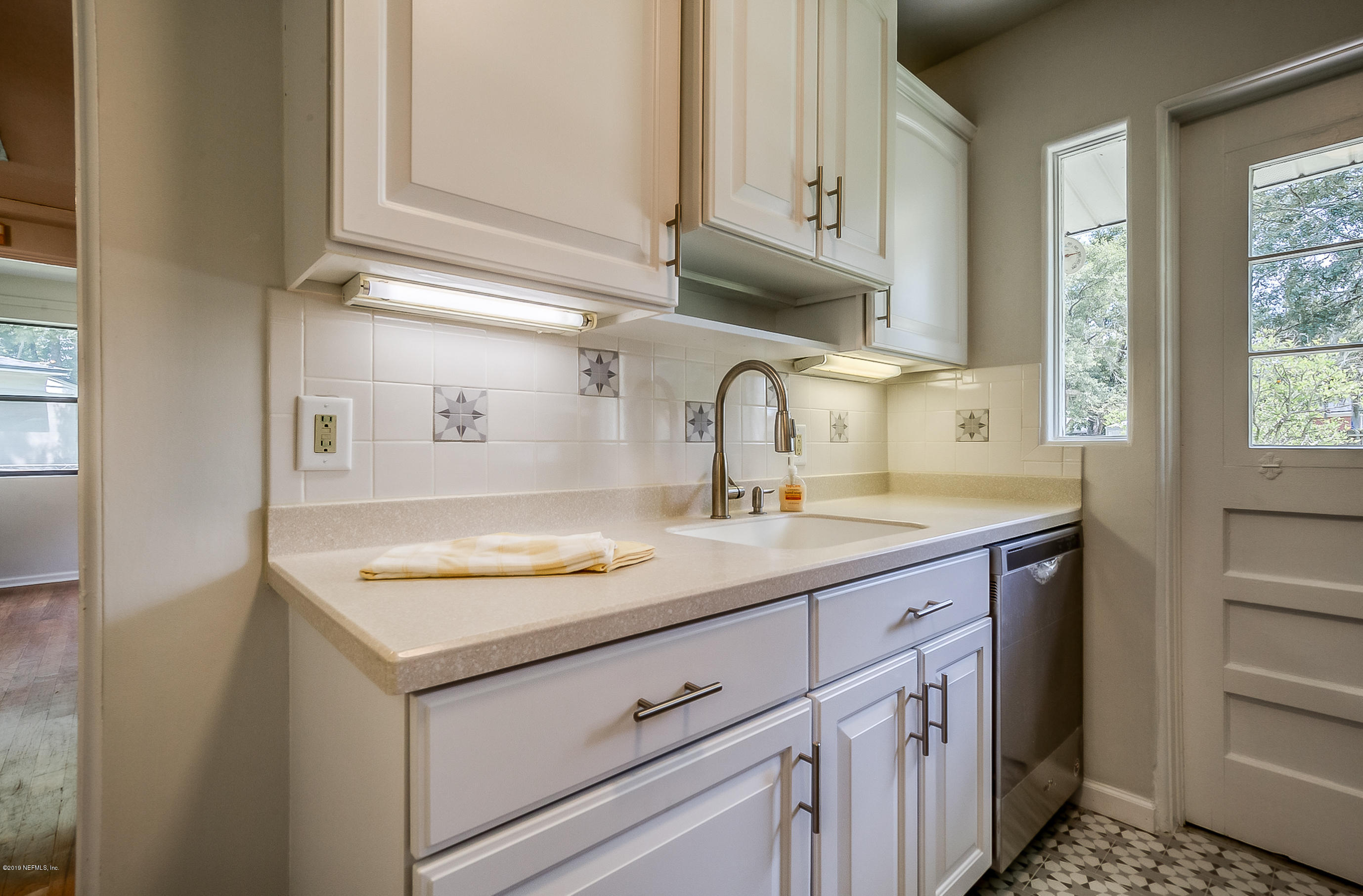 4548 Milstead Road Jacksonville, FL 32210 - Photo 32 of 37 a kitchen with a sink and cabinets