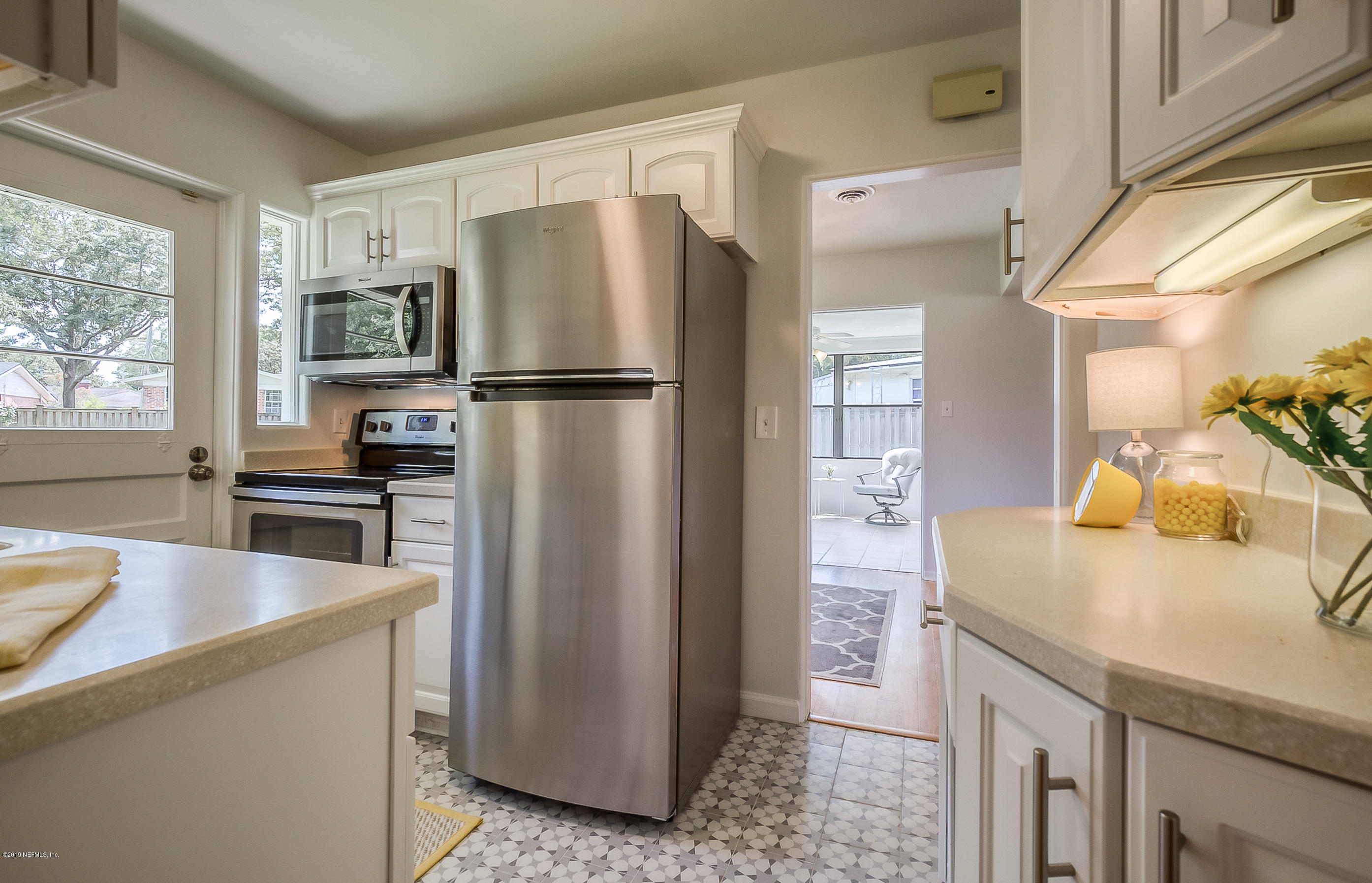 4548 Milstead Road Jacksonville, FL 32210 - Photo 34 of 37 a kitchen with a refrigerator and a sink