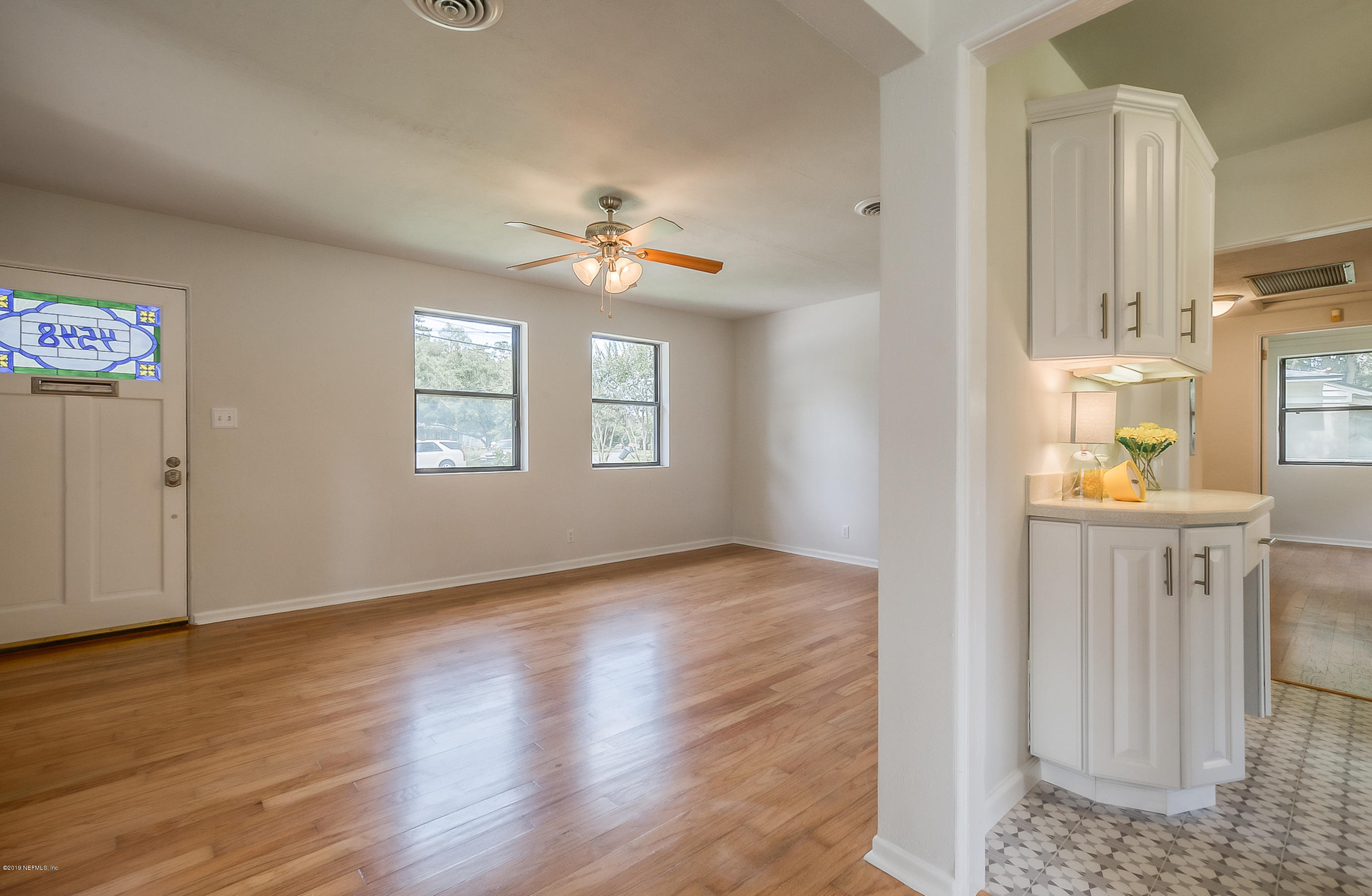 4548 Milstead Road Jacksonville, FL 32210 - Photo 37 of 37 wooden floor in an empty room with a window