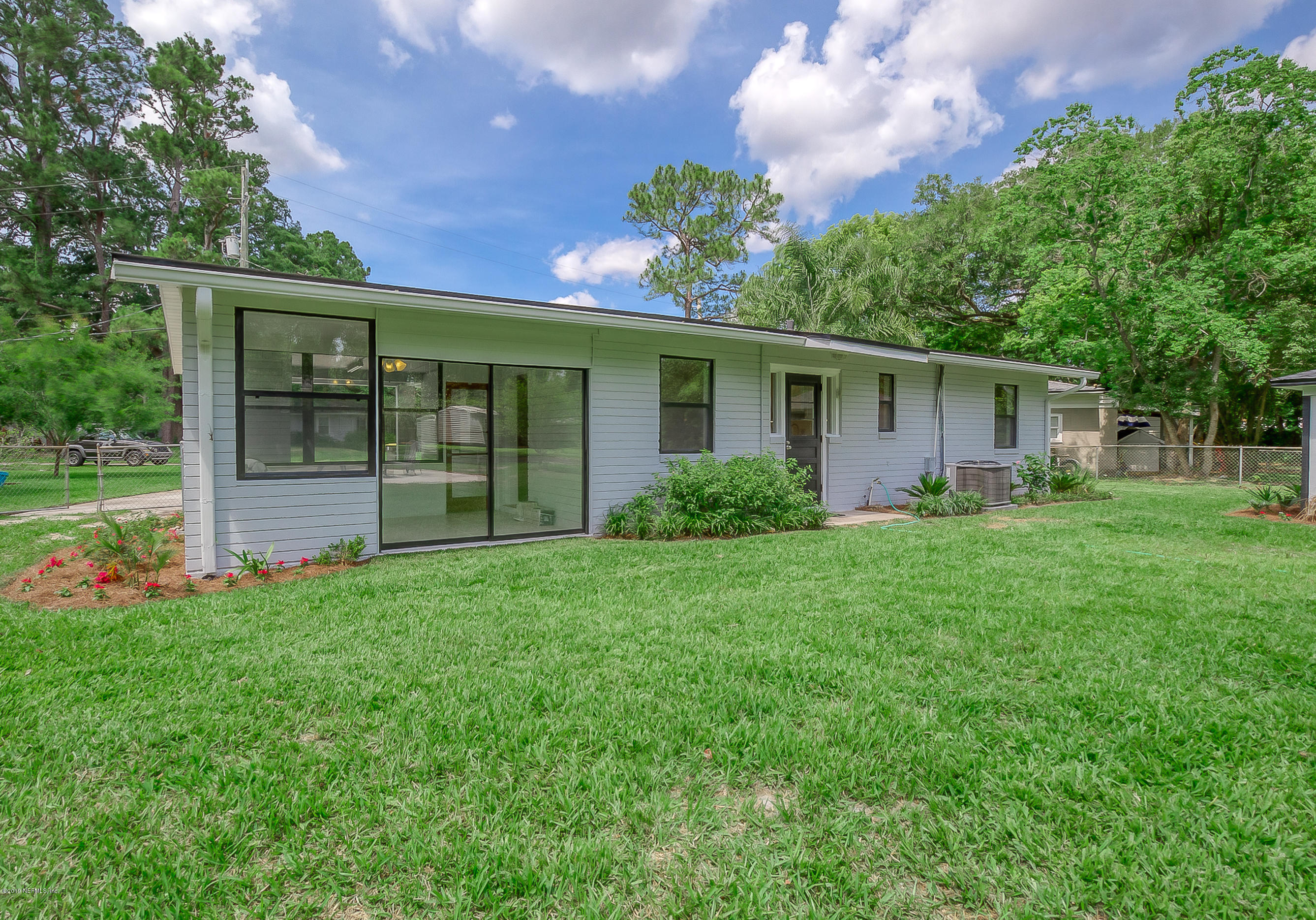 4548 Milstead Road Jacksonville, FL 32210 - Photo 5 of 37 a front view of house with yard and green space