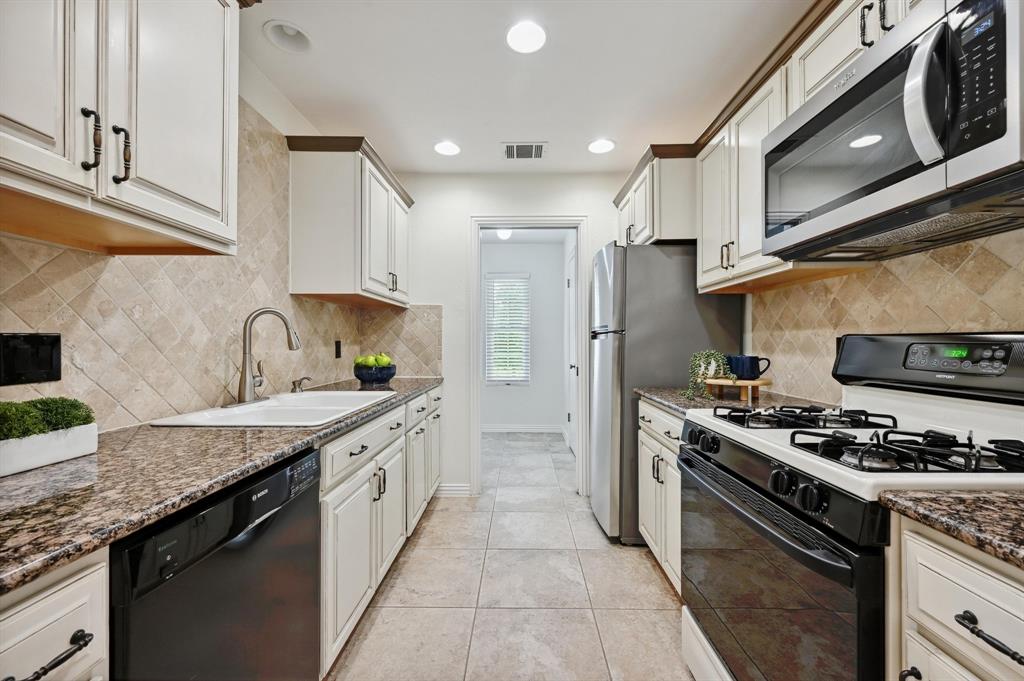 2406 Burly Oak Drive Austin, TX 78745 - Photo 11 of 21 a kitchen with stainless steel appliances granite countertop a sink stove and cabinets