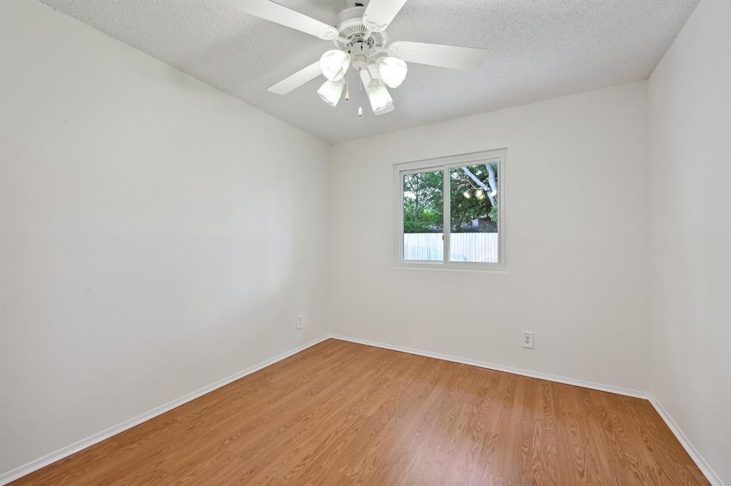 2406 Burly Oak Drive Austin, TX 78745 - Photo 14 of 21 wooden floor in an empty room with a window