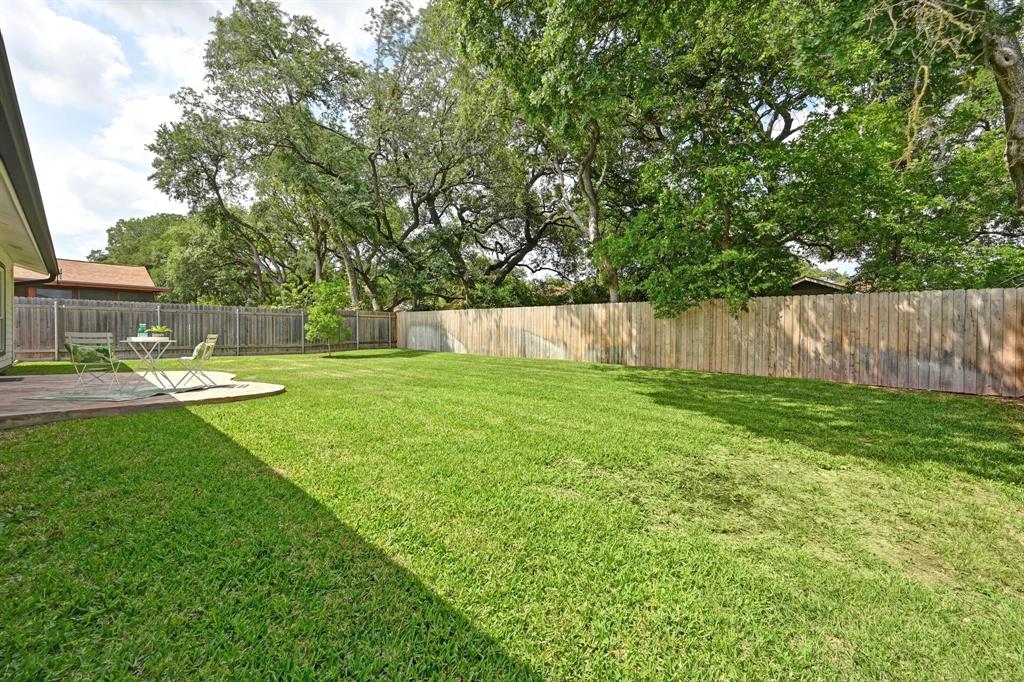 2406 Burly Oak Drive Austin, TX 78745 - Photo 15 of 21 a view of a park with large trees and a wooden fence