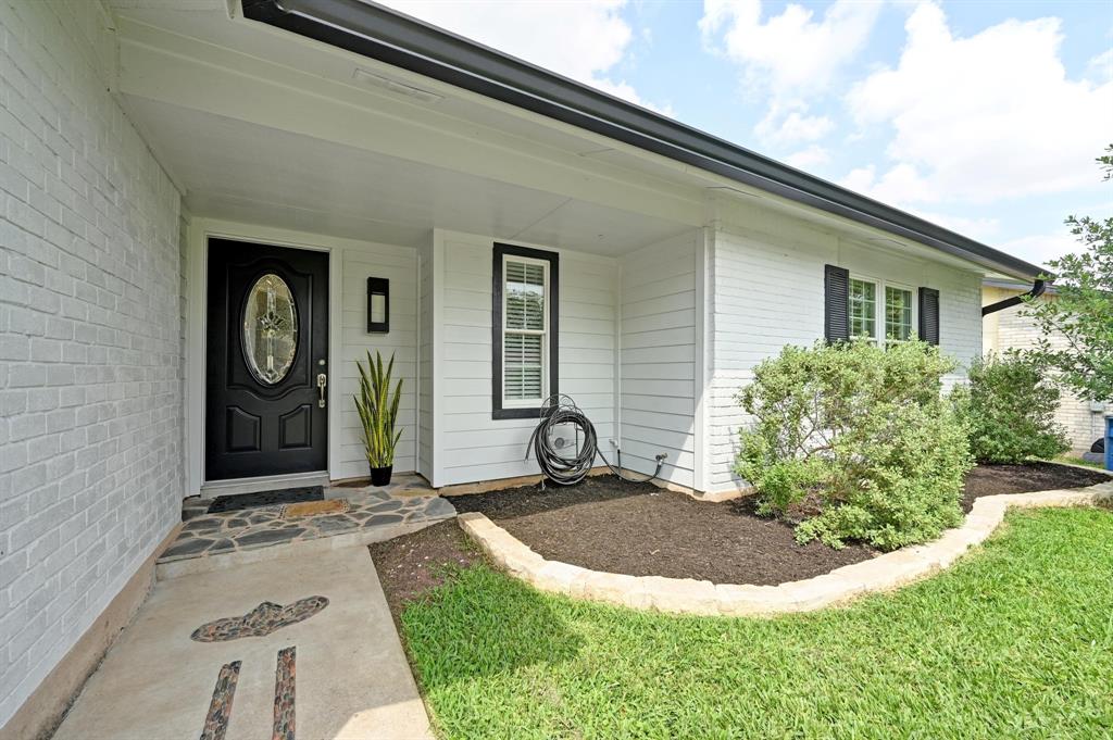 2406 Burly Oak Drive Austin, TX 78745 - Photo 18 of 21 a front view of a house with garden