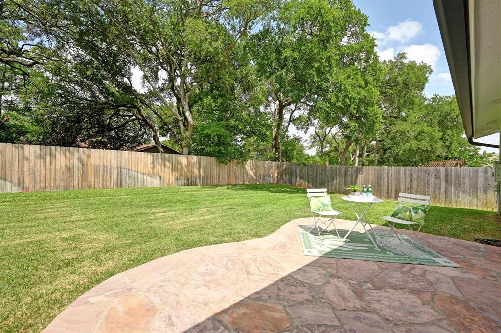 2406 Burly Oak Drive Austin, TX 78745 - Photo 21 of 21 a backyard of a house with table and chairs