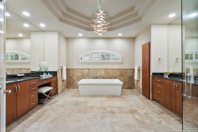 a large kitchen with a large island in the center and stainless steel appliances