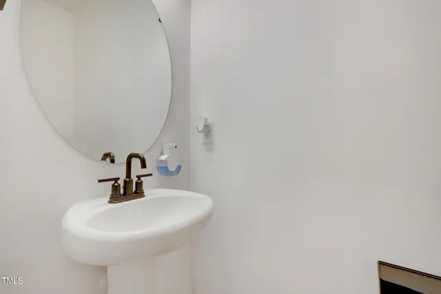 a bathroom with a sink and mirror