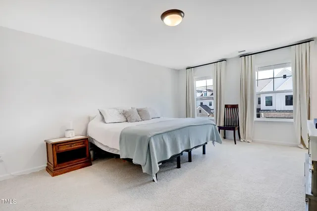 a spacious bedroom with a bed and a cabinets