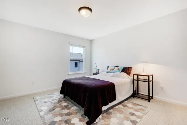 a bedroom with a bed and a lamp