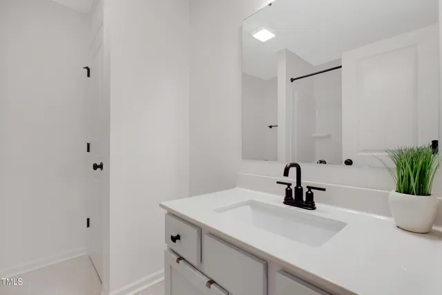 a bathroom with a sink a tub and mirror