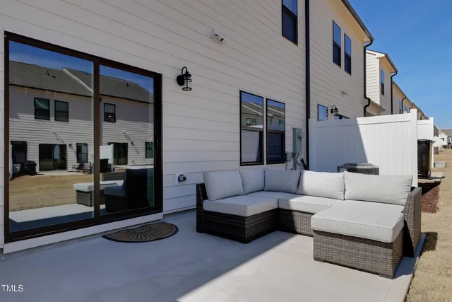 a view of a patio with couches and a fireplace