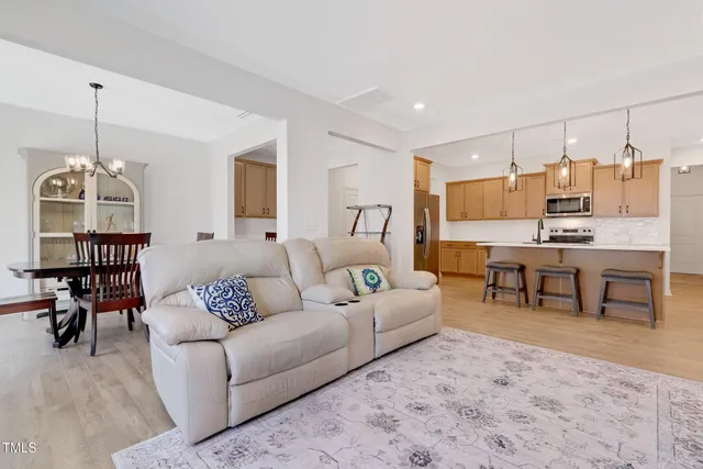 a living room with furniture and kitchen view